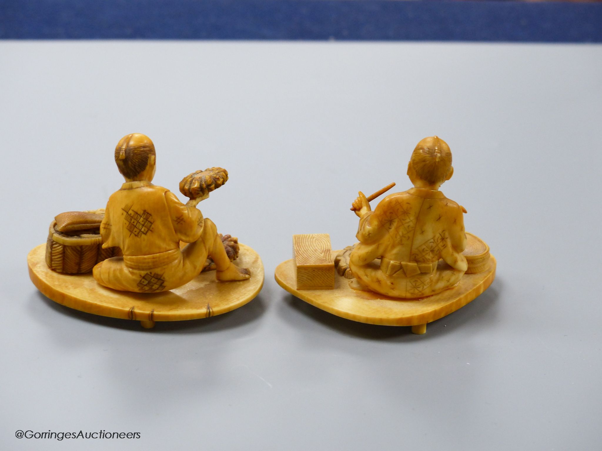 Two Japanese ivory okimono of a craftsman